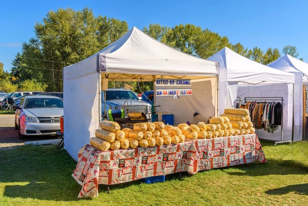 A popcorn, kettle corn, and caramel popcorn tent and kiosk at an Autumn harvest festival