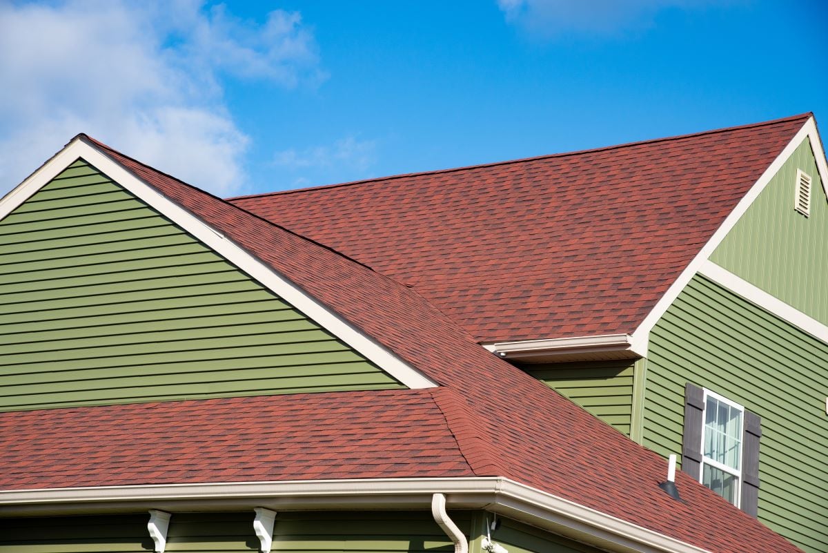 green house with brown roof against blue sky