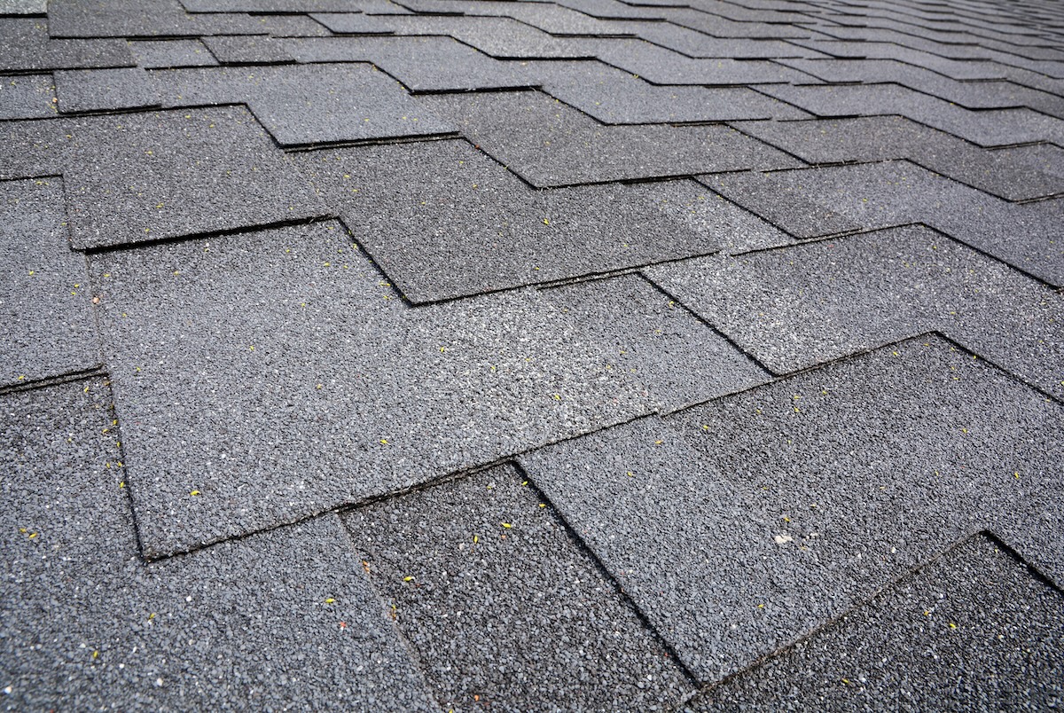 Close up view on Asphalt Roofing Shingles Background. Roof Shingles - Roofing.