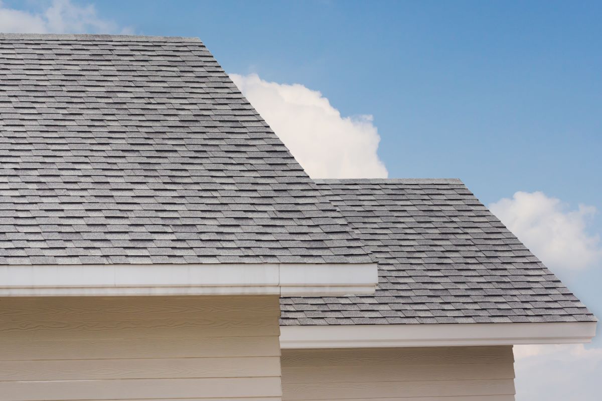 gray roof shingles against blue sky