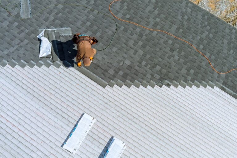 roofer installing asphalt shingles
