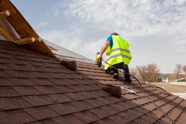 roofer installing shingles