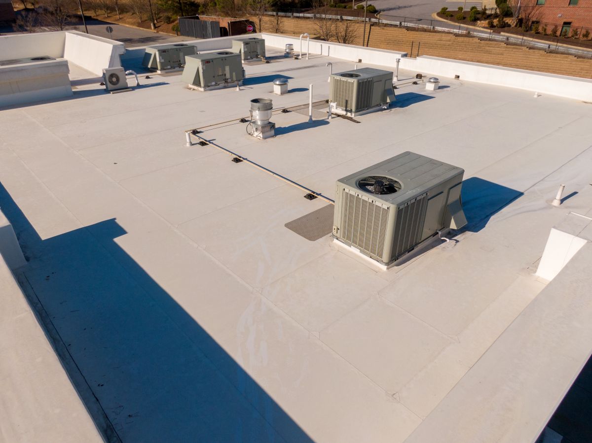 High Resolution Sunny Aerial Drone Image of a New TPO Roof on a Commercial Building With Visible HVAC Equipment