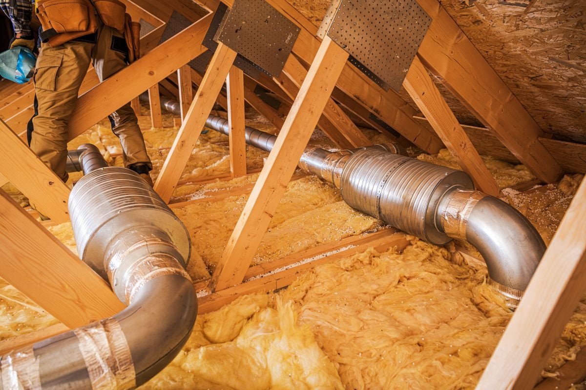 Home Ventilation Installation in an Attic With Insulation and Ductwork