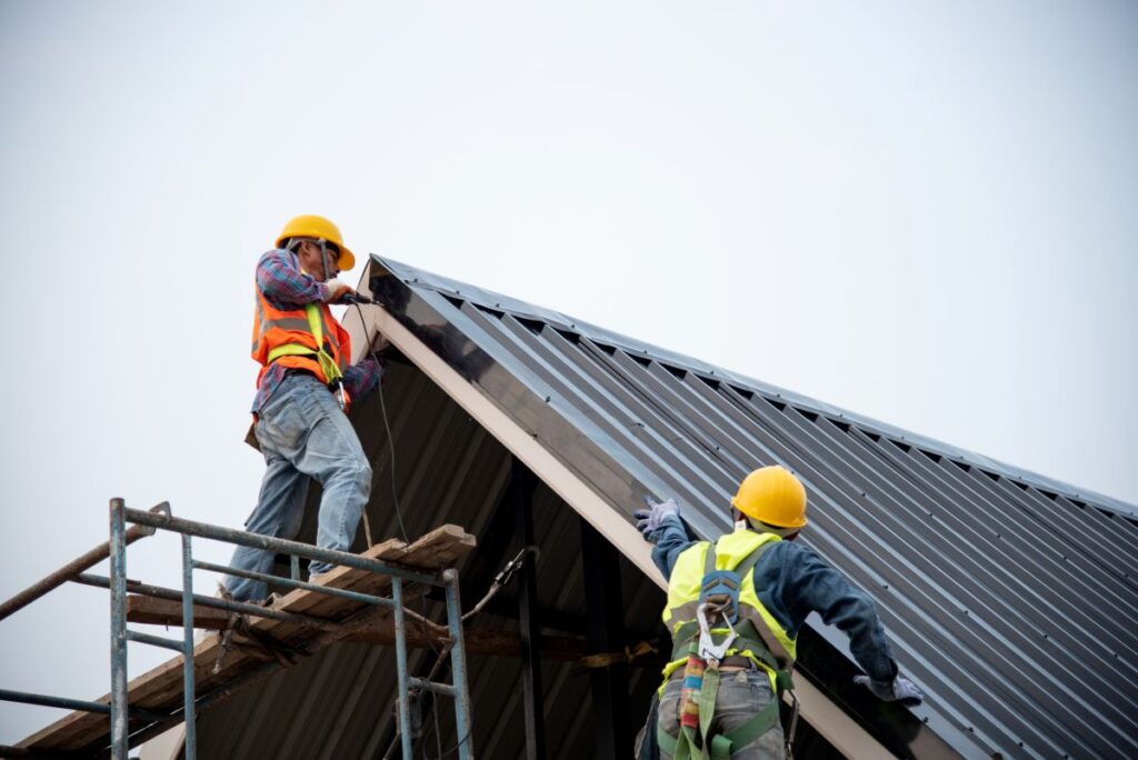 Technician is Work Roof Repair Construction engineer wear safety uniform inspection metal roofing work for roof