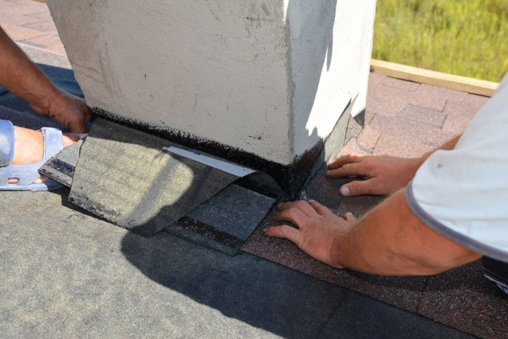 chimney flashing repair workers using shingles roof