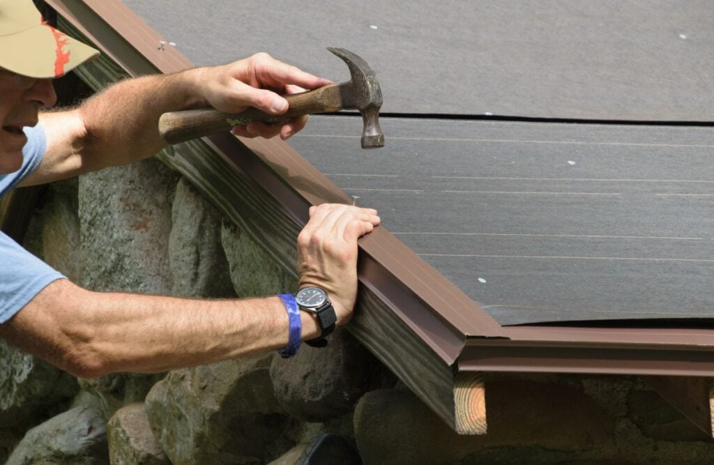 drip edge flashing mature worker using hammer to install roof