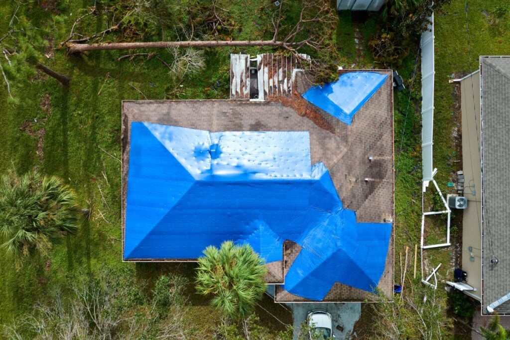 hail damage roof blue tarp after storm