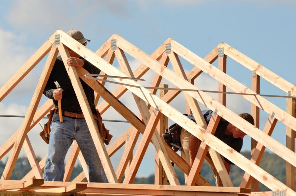 roof trusses workers installing new house