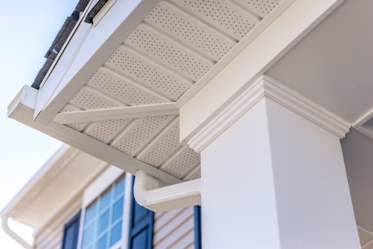 Colonial white custom porch columns with wood looking vinyl column wrap, sheets and molding, white soffit provides optimal ventilation for roof overhangs