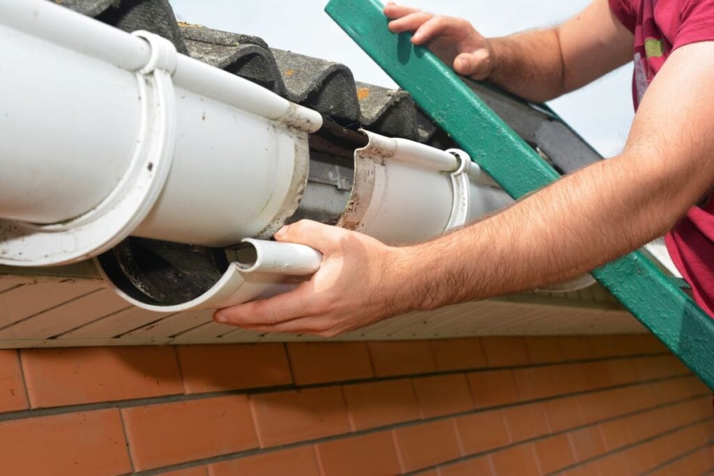 gutter replacement worker installing white water system