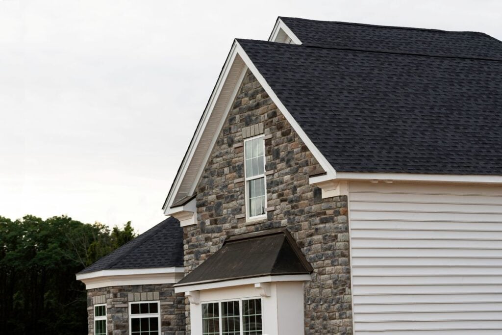 black shingles huge house white siding