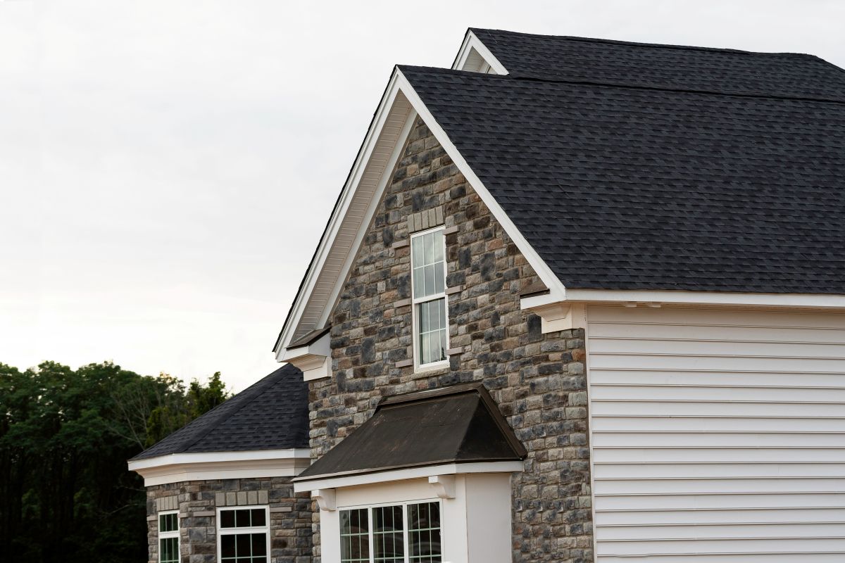 black shingles huge house white siding