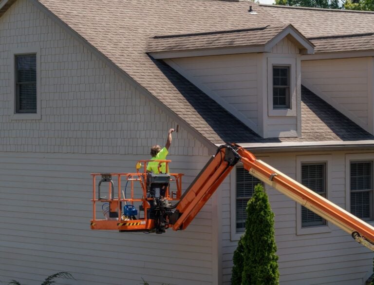 can you paint vinyl siding worker painting house