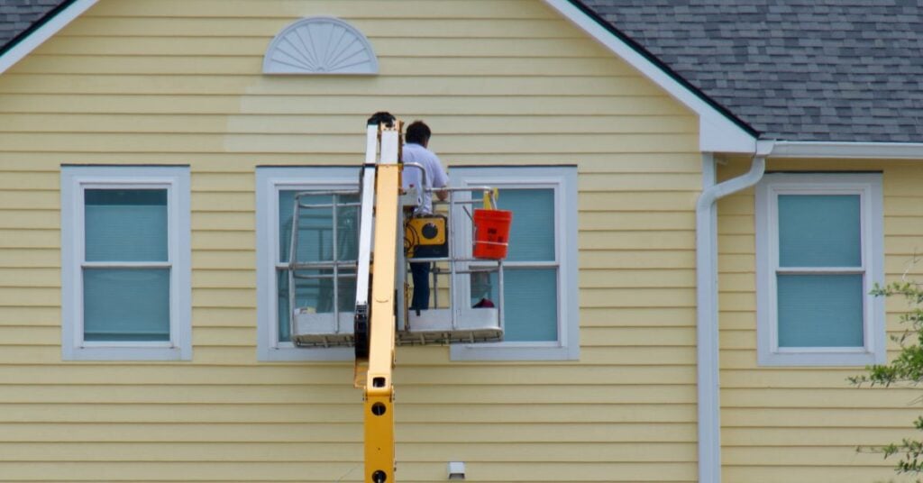 can you paint vinyl siding worker painting house