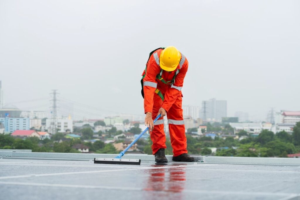 commercial roof cleaning worker using tool