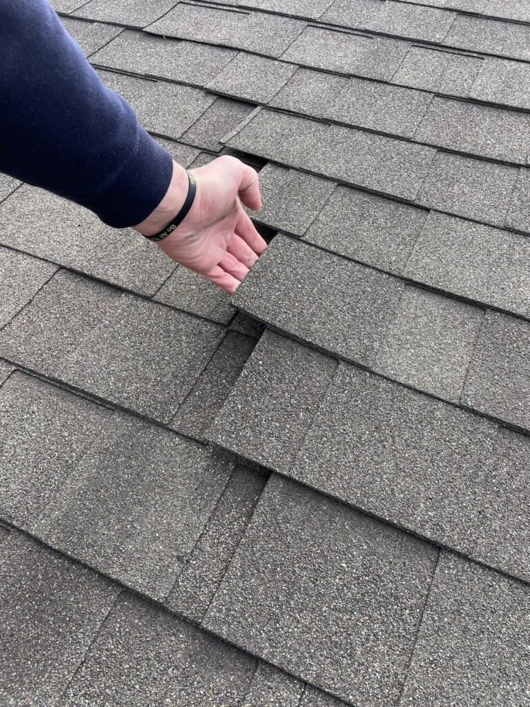 roofing tips hand pulling out shingles