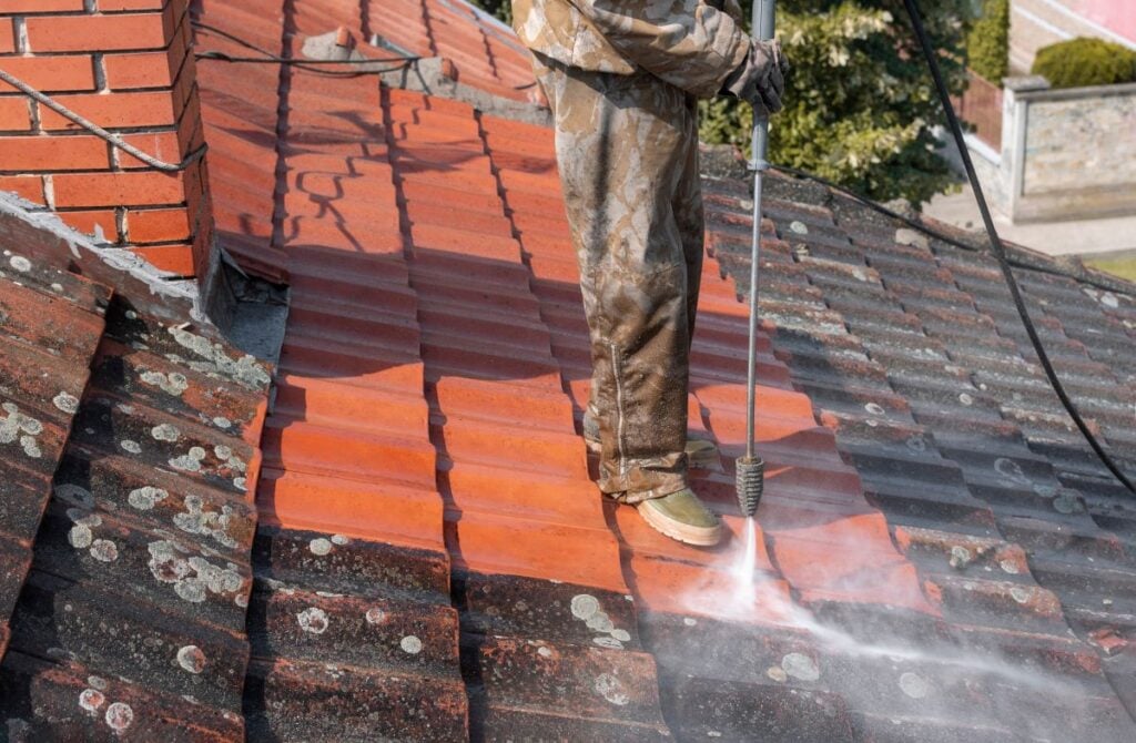soft wash roof cleaning hose removing black stains