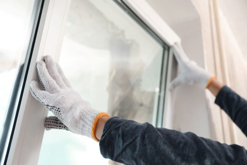 window installation worker using white gloves