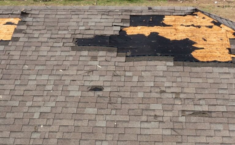 Tornado damage to roof with missing shingles.