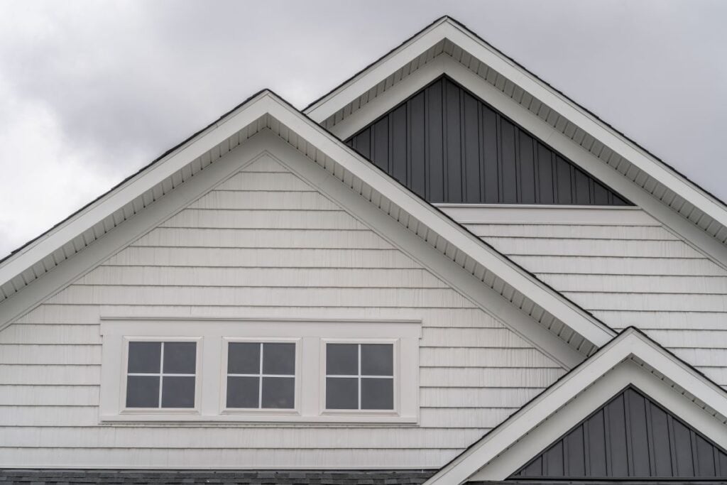 white horizontal vinyl siding, dark vertical siding