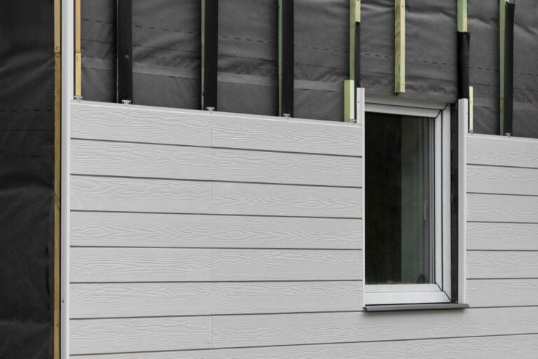 wood texture composite siding being installed