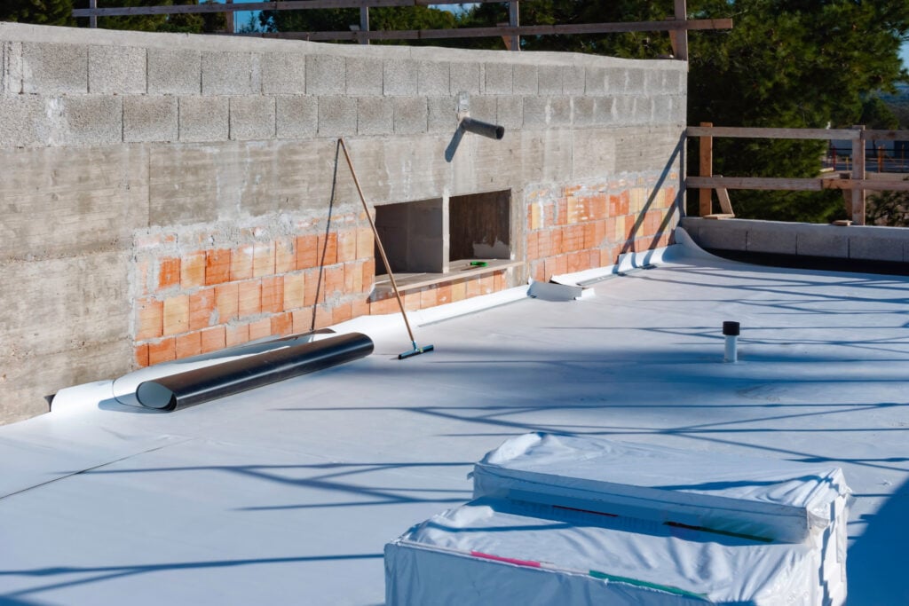 Worker on application Synthetic waterproofing PVC-P and TPO / FPO commercial flat roof replacement