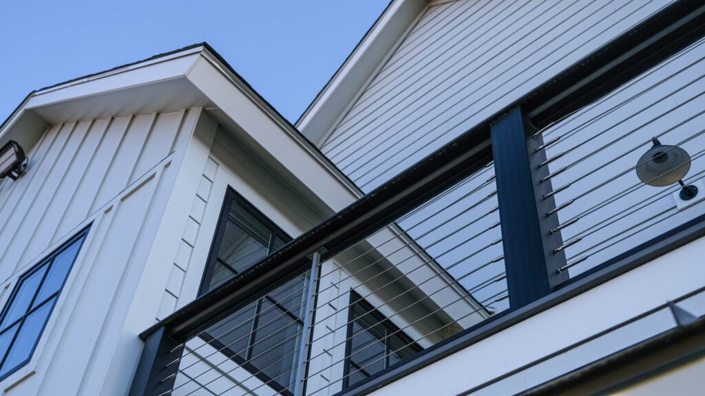 fiber cement siding installation white siding black railing
