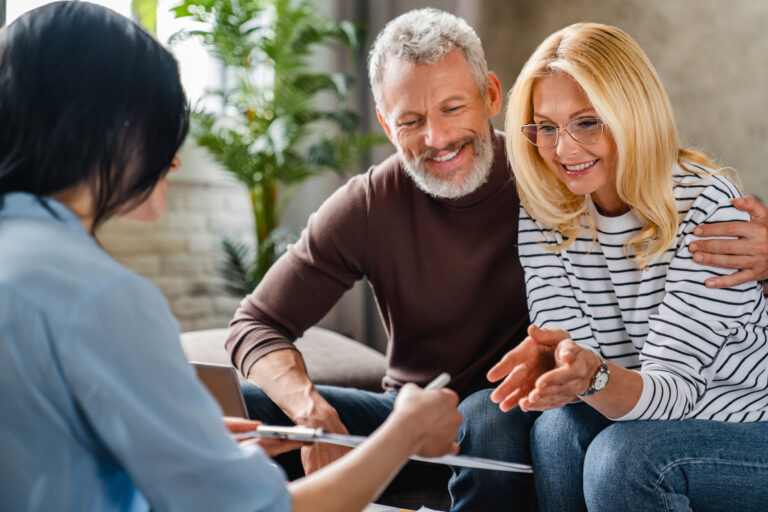 does homeowners insurance cover roof leaks Estate agent or financial adviser showing terms of contract to happy couple on notepad