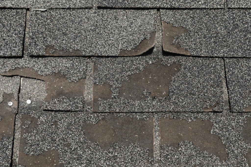 hail damage roof repair Roof in need of repair damaged asphalt roofing shingles architecture construction background texture pattern abstract concept