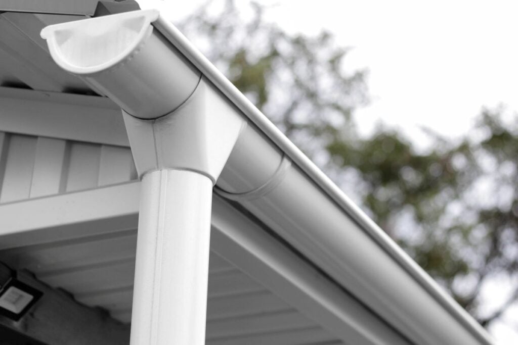Drainage system of white painted metal. Close up