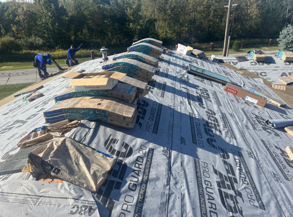 damaged shingles Discount roof workers replacing big roof