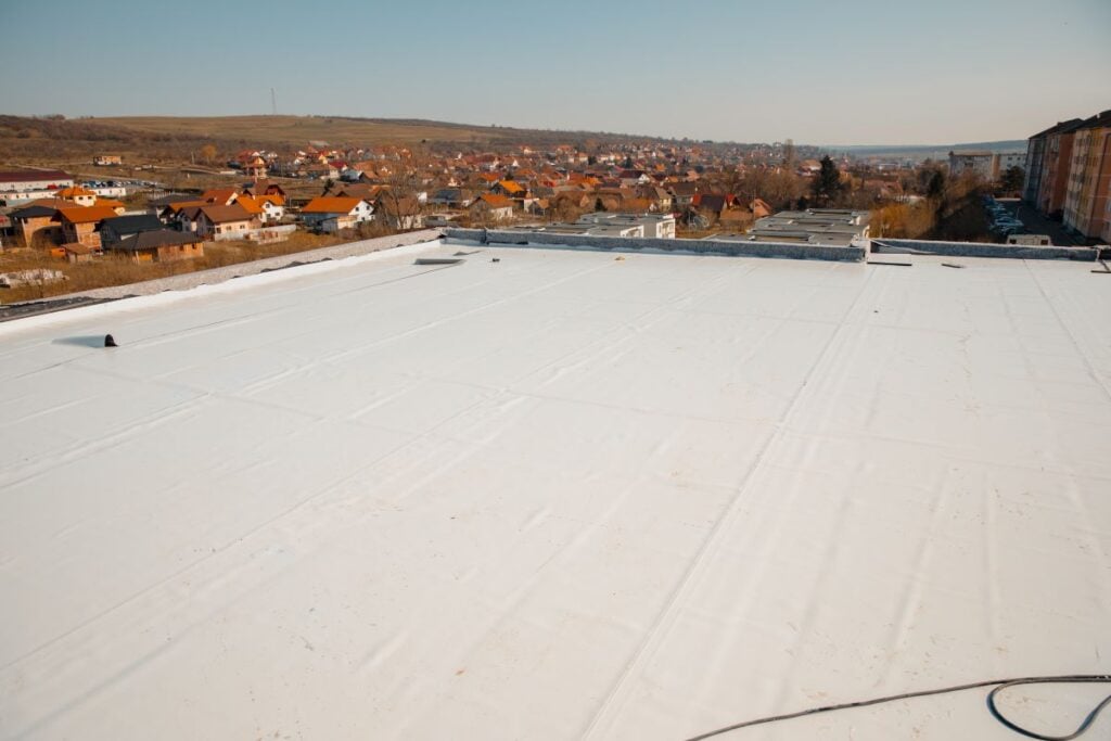 commercial flat roof replacement white TPO blue sky