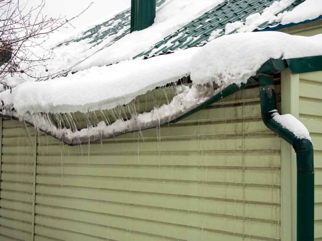 gutter repair cost ice dams and snow on top of roof