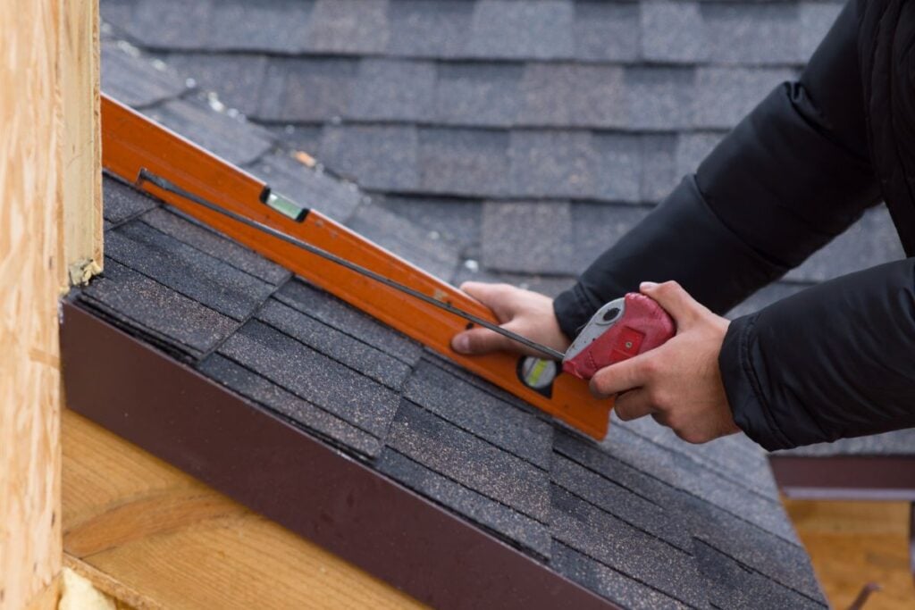 how to measure a roof for metal roofing worker using ruler on shingles roof