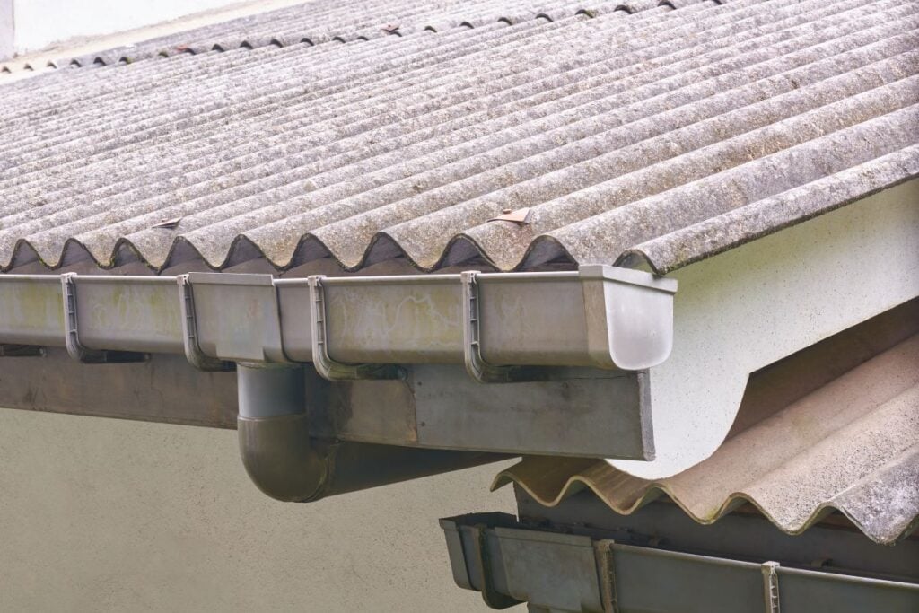 seamless vs sectional gutters grey metallic old roof