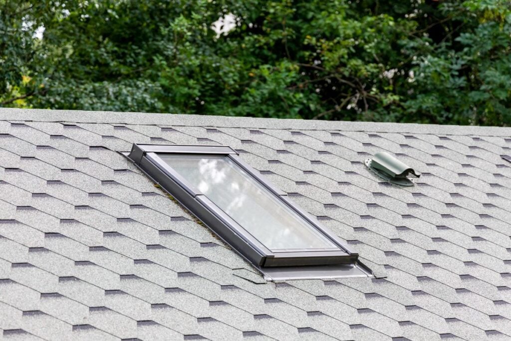 signs of poor attic ventilation grey shingles roof small window